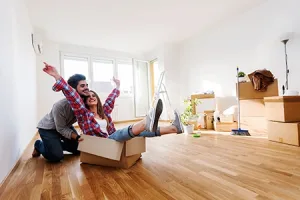 Couple Unpacking Boxes in Their New Home – New Adventures
