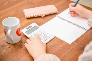 someone doing calculations with their coffee